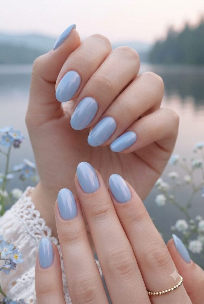 Short oval nails with soft iris blue glossy lake polish