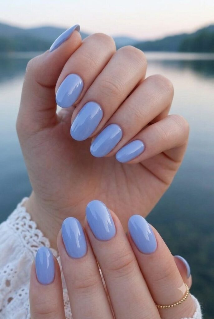 Short oval nails with soft periwinkle blue glossy polish