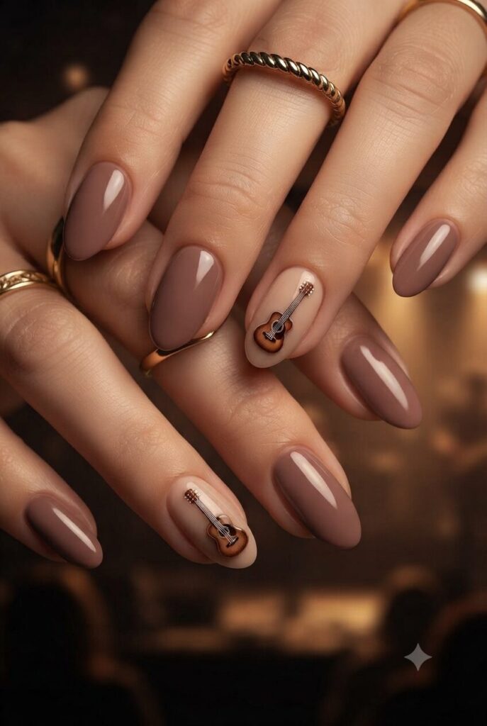 Short almond nails with nude base and tiny brown guitar accent