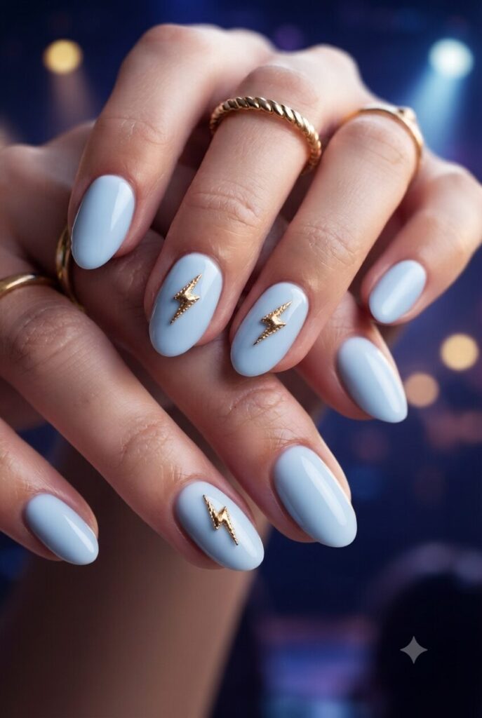 Short almond nails with blue base and tiny gold lightning bolt accents