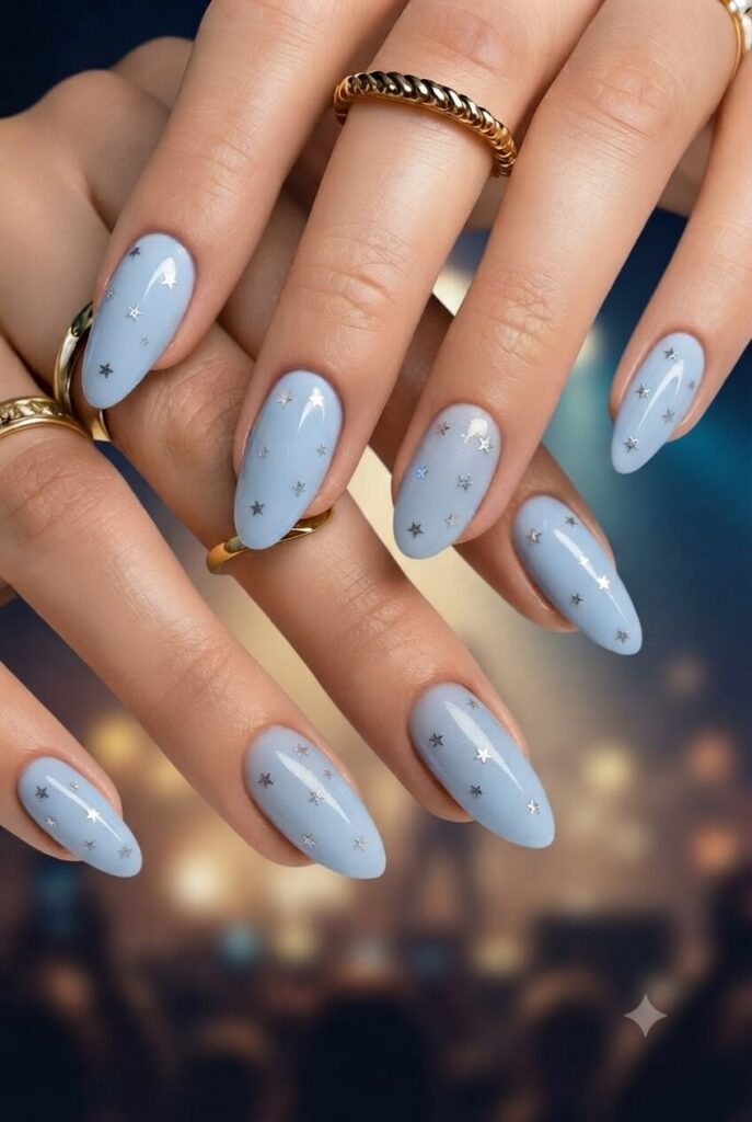 Short almond nails with blue base and tiny silver star accents