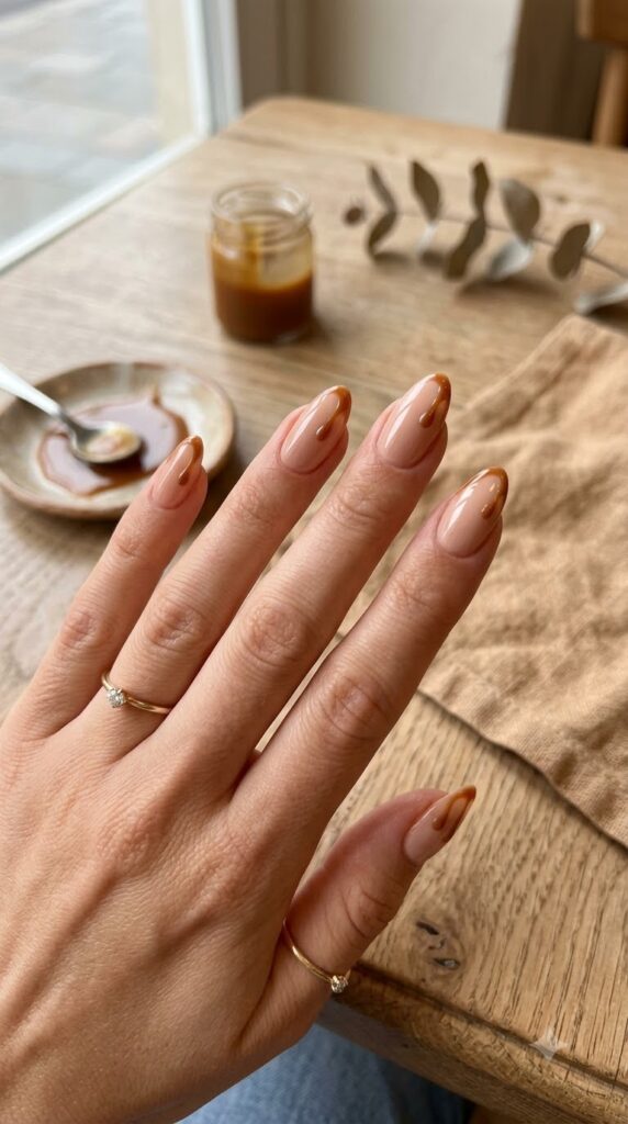 Nude nails with caramel drip accents for September