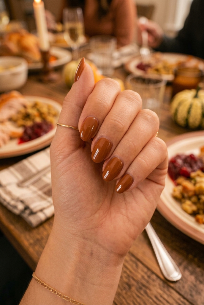 Short oval nails with glossy warm cinnamon brown polish