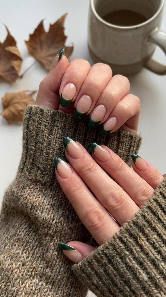 Almond nails with nude base and forest green side French tips