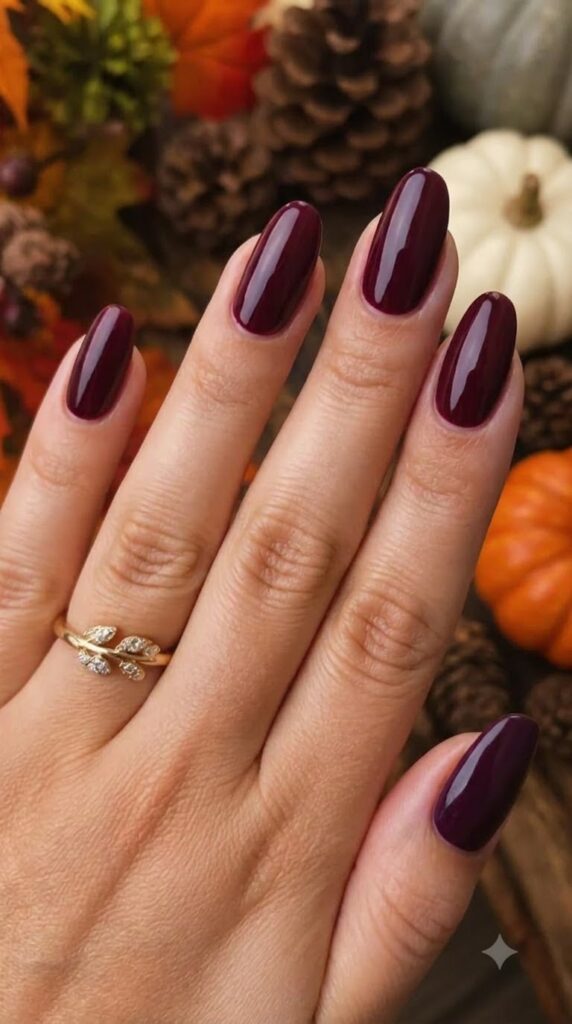 Medium almond nails with glossy deep burgundy polish