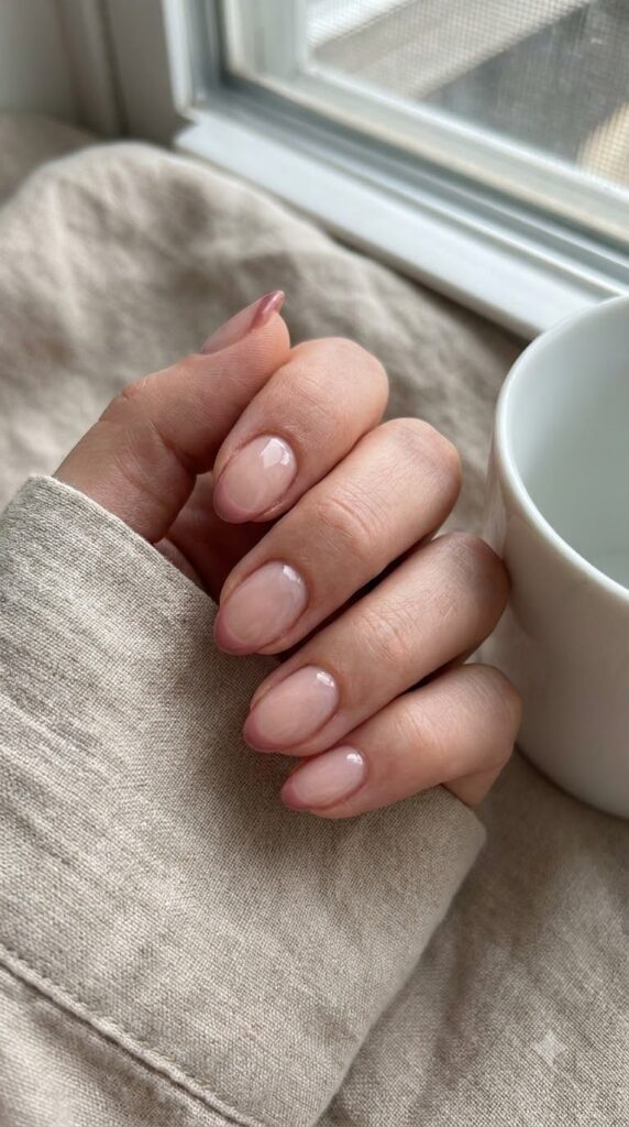 Short almond nails with thin dusty rose tip outlines