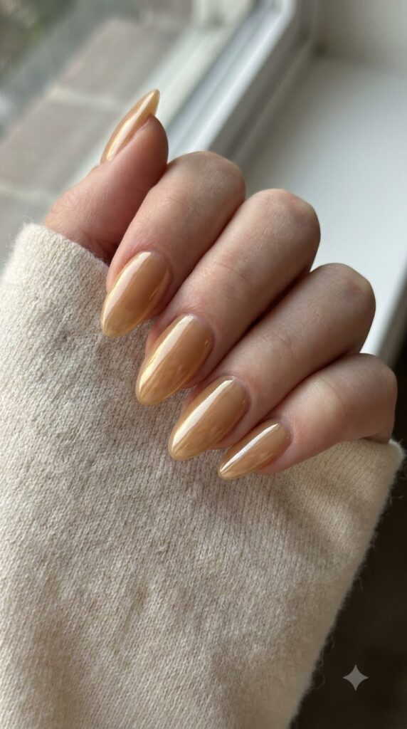 Medium almond nails with sheer golden honey nude glaze polish