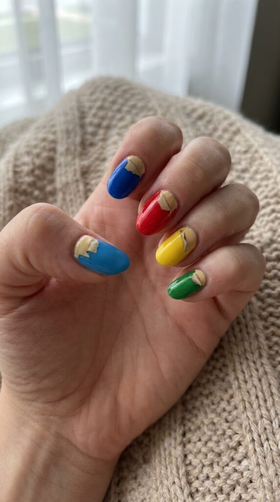Bright nails with peeled crayon wrapper detail near the cuticle