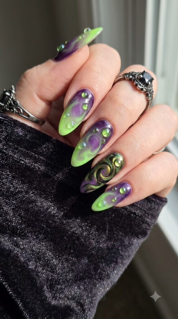 Almond nails mixing purple and green polish with potion bubbles