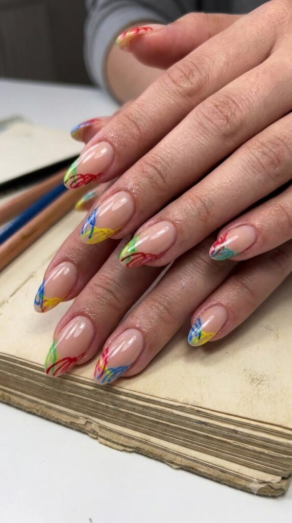 Nude nails with bright scribble French outline design