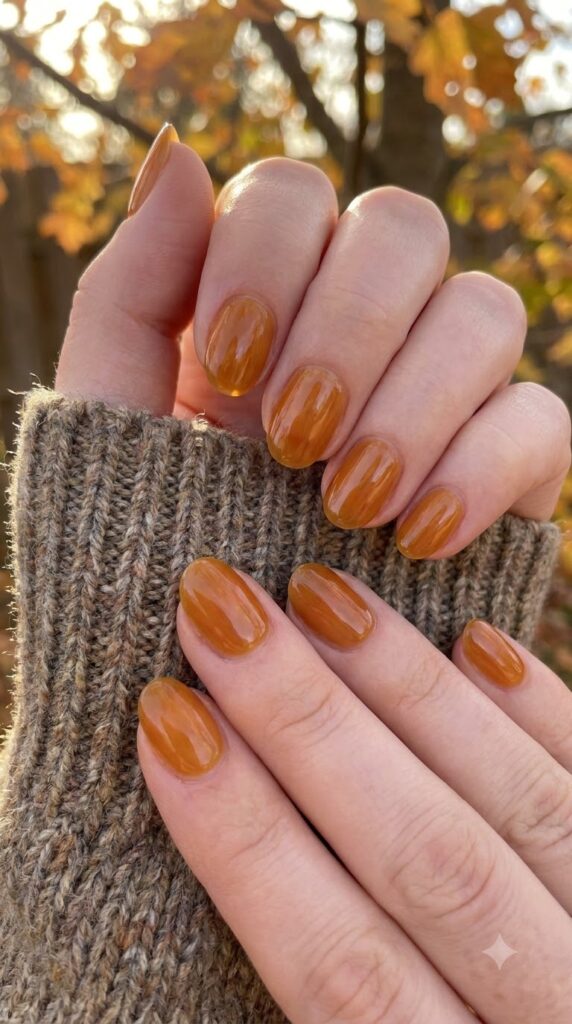 Short oval nails with translucent amber honey jelly polish