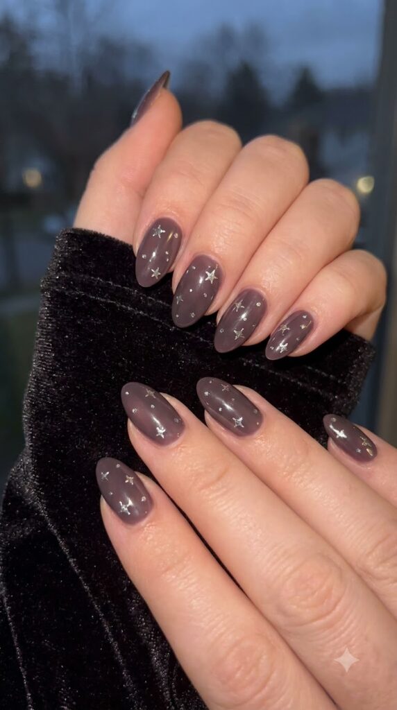 Almond nails with smoky mauve polish and silver star decals