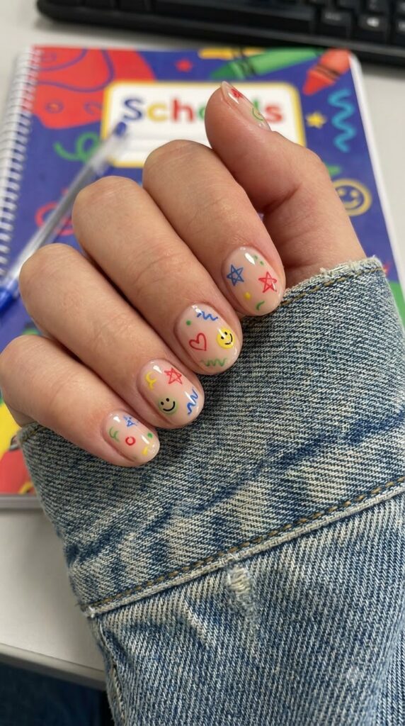 Nude nails with tiny doodles in bright crayon shades