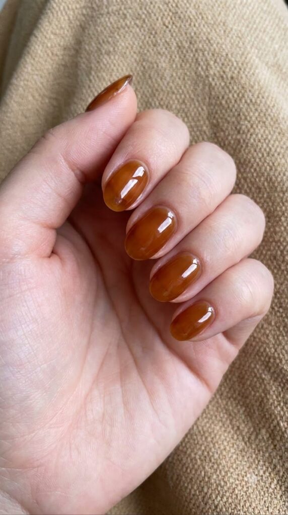 Short oval translucent amber jelly brown nails with honey glass shine