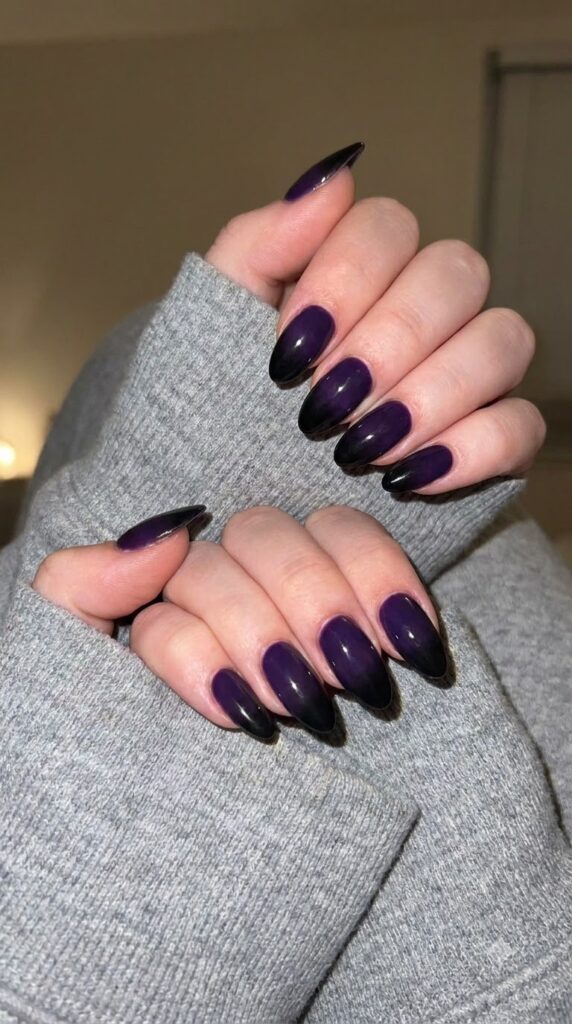 Medium almond nails with dark violet purple fading into solid black tips