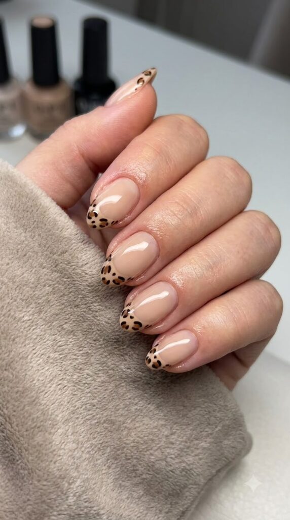 Short almond nude nails with brown and black leopard print French tips
