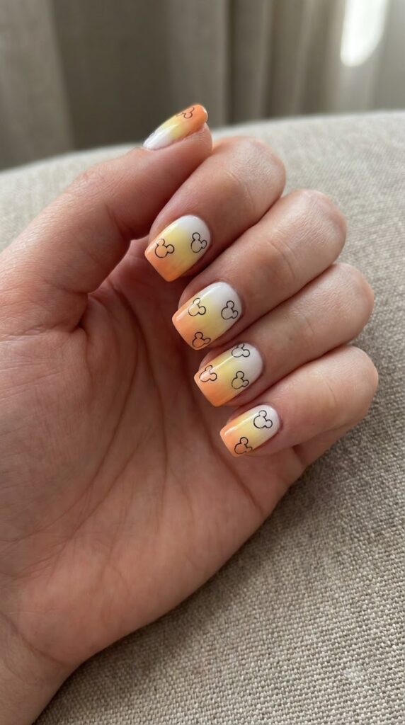 Short square nails with yellow orange white tips and Mickey ears