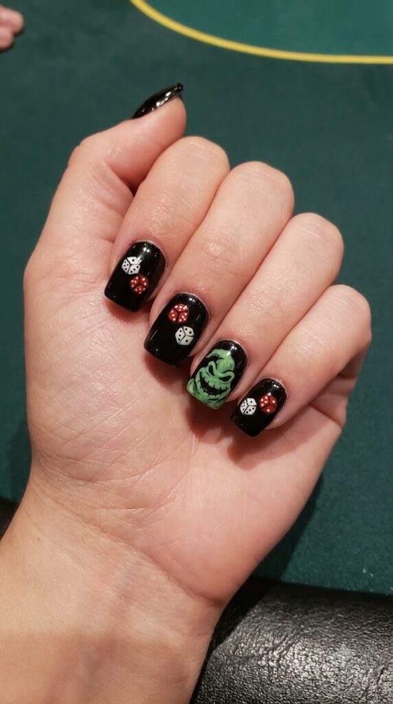 Short square black nails with red casino dice and green Oogie smirk accent