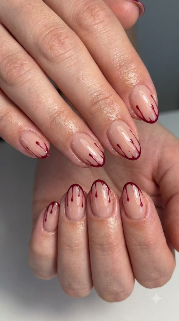 Short squoval nude nails with crisp cinnamon red French tips