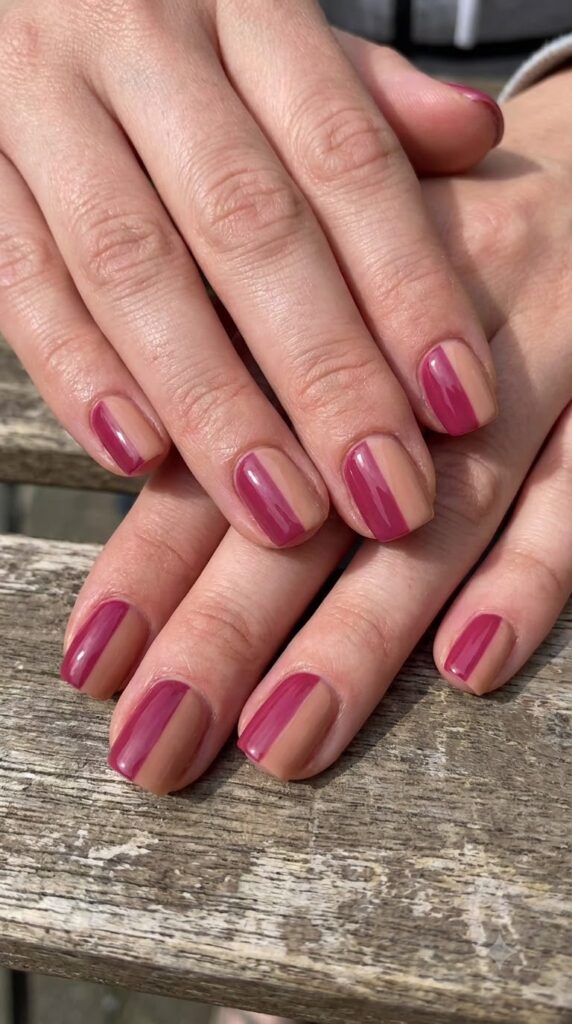 Short square nails split vertically with deep berry pink and warm nude polish