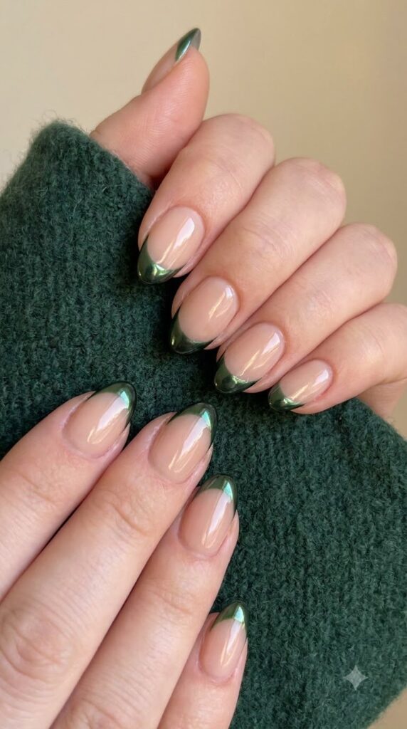 Short almond nude nails with reflective dark forest green chrome French tips