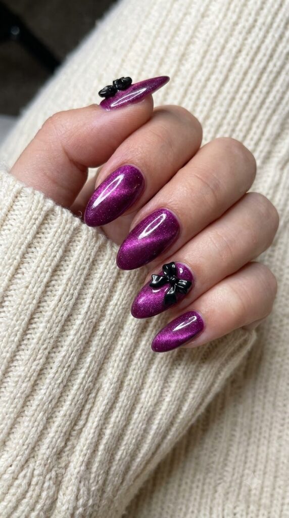 Medium almond magenta purple cat-eye velvet nails with 3D black bows