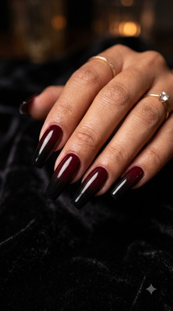 Long coffin dark wine red nails dissolving into solid midnight black tips