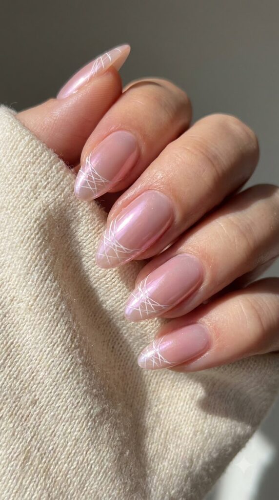 Almond glazed pink chrome nails with ultra-thin white spiderweb tips