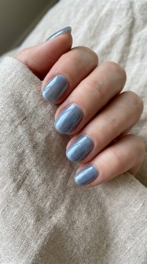 Short natural round dusty slate blue nails with glazed chrome powder finish