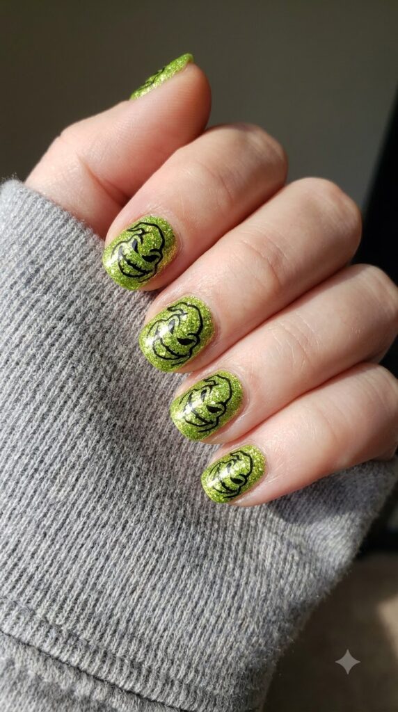 Short round chunky lime green glitter nails with black Oogie face outline
