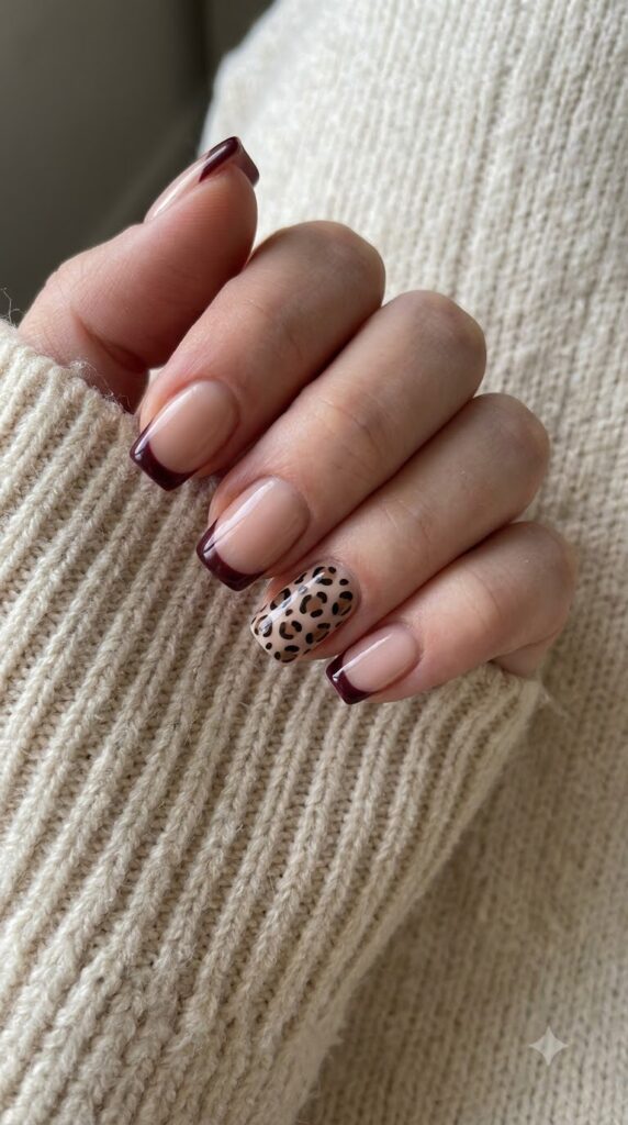 Medium square nude nails with burgundy French tips and leopard print accent