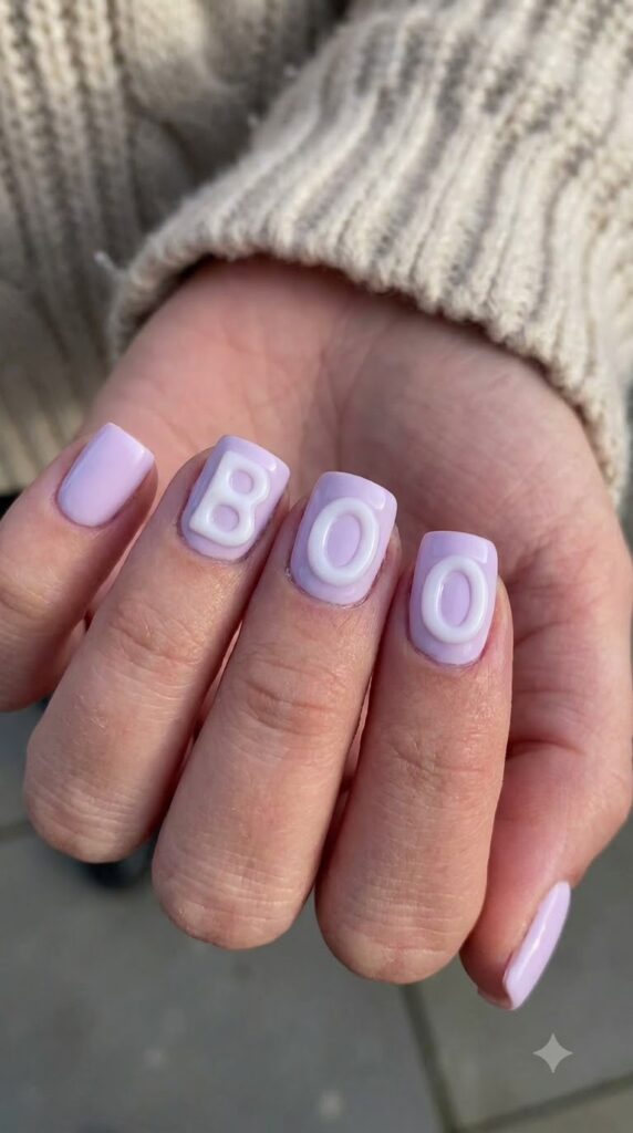 Short square light lavender nails with raised 3D white gel BOO lettering