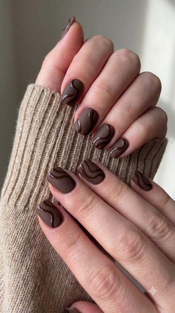 Short square matte espresso brown nails decorated with glossy chocolate swirls