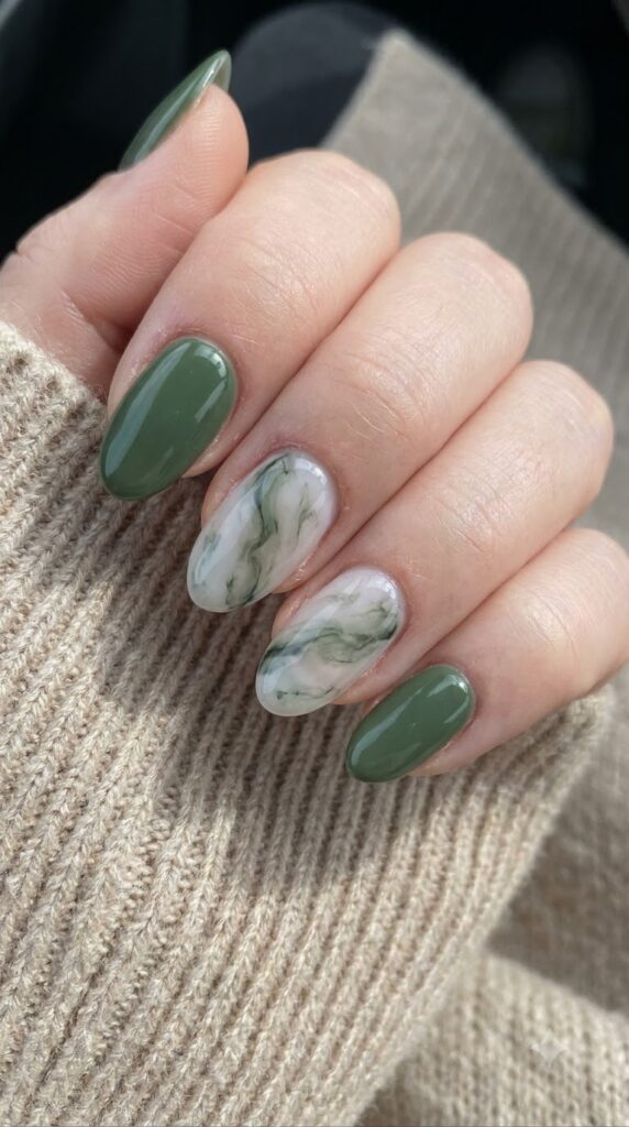 Oval nails with white marble base, moss green veins, and solid green nails