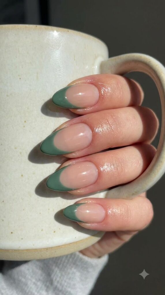 Almond nude gel nails with deep sage green side-swept French tips