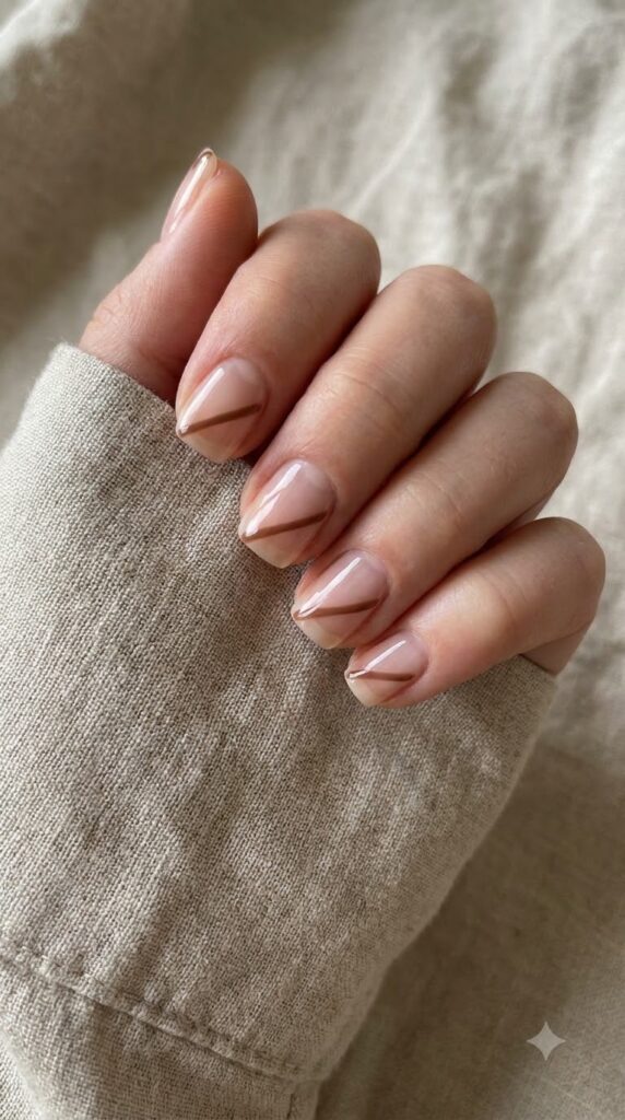 Short square natural nails with clear negative space and diagonal brown shape