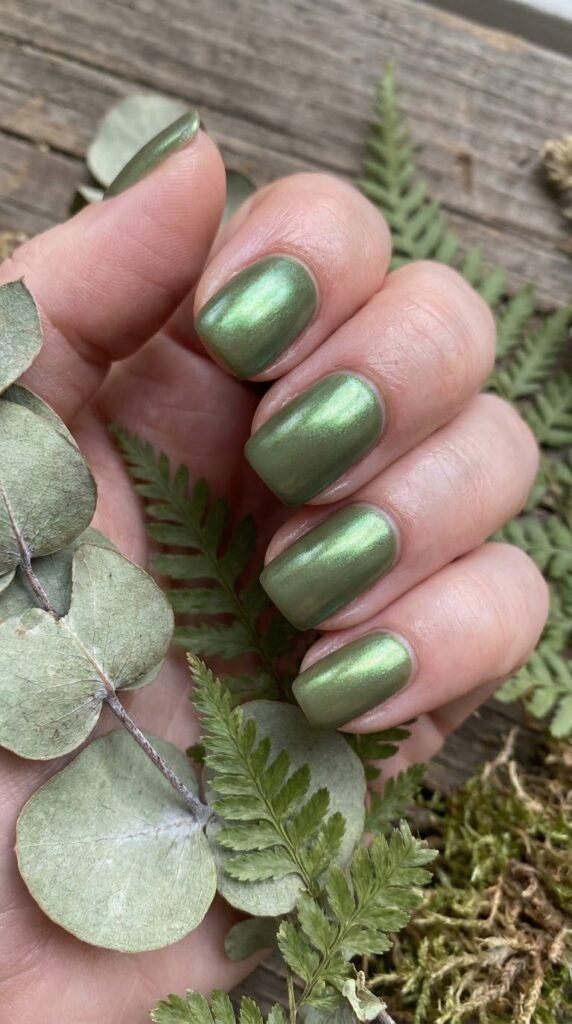 Short squoval earthy olive green nails finished with green metallic chrome