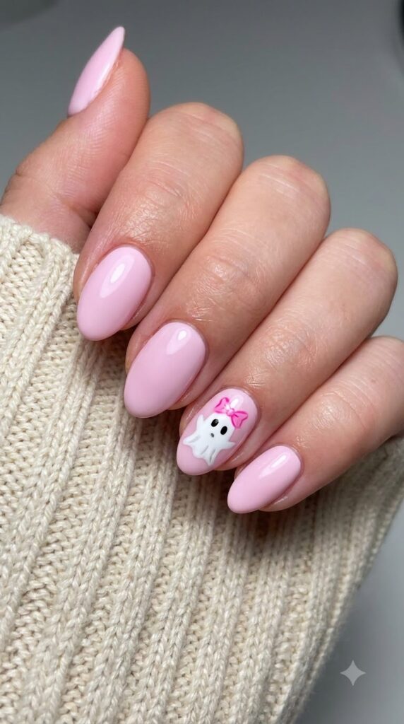 Short almond pastel pink nails with tiny white ghost wearing a pink bow