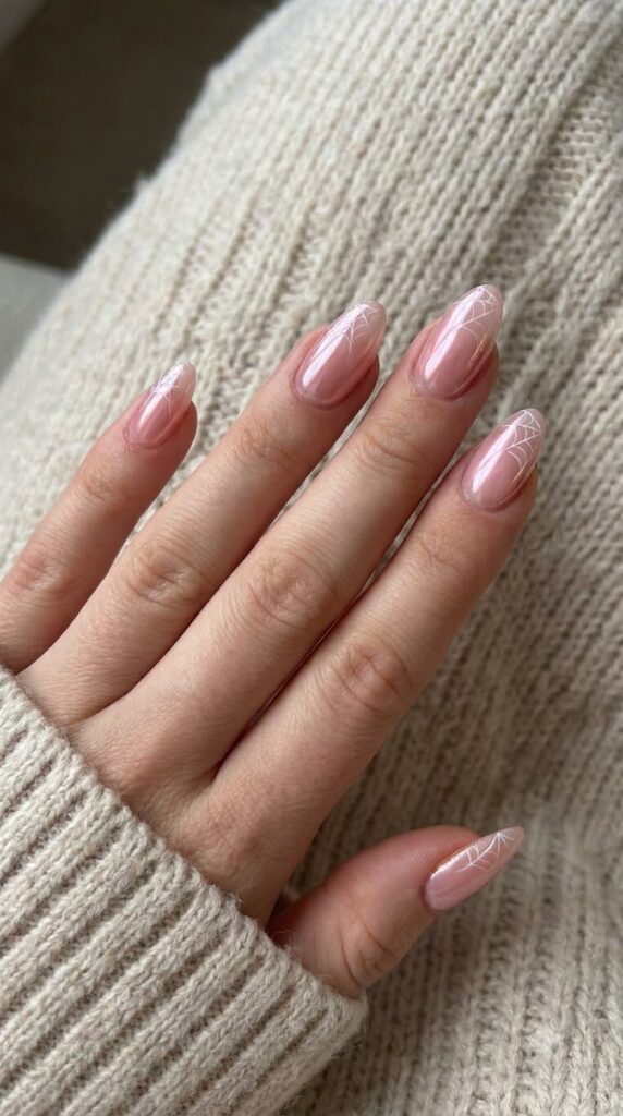 Almond glazed pink chrome nails with ultra-thin white spiderweb tips
