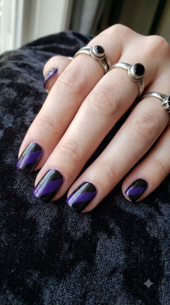 Short square nails with purple and black diagonal witch stocking stripes