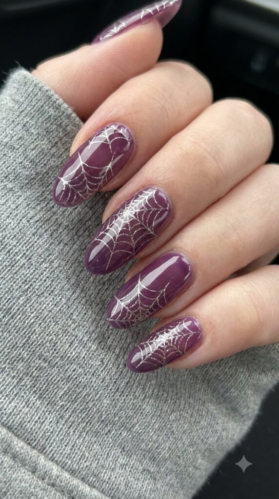 Long oval grape jelly nails with floating metallic silver cobweb line art