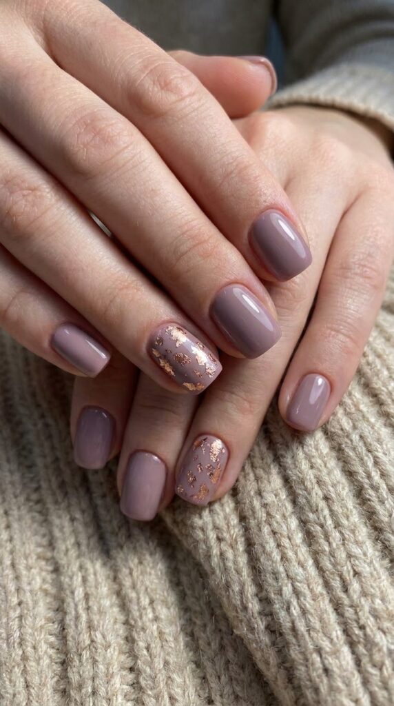Short squoval dusty mauve nails decorated with rose gold leaf foil flecks
