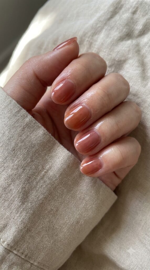 Short oval translucent dusty rose amber jelly nails with honey glass shine