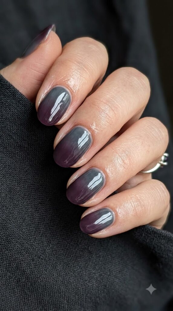 Short oval smoky grey charcoal nails fading into deep plum purple tips