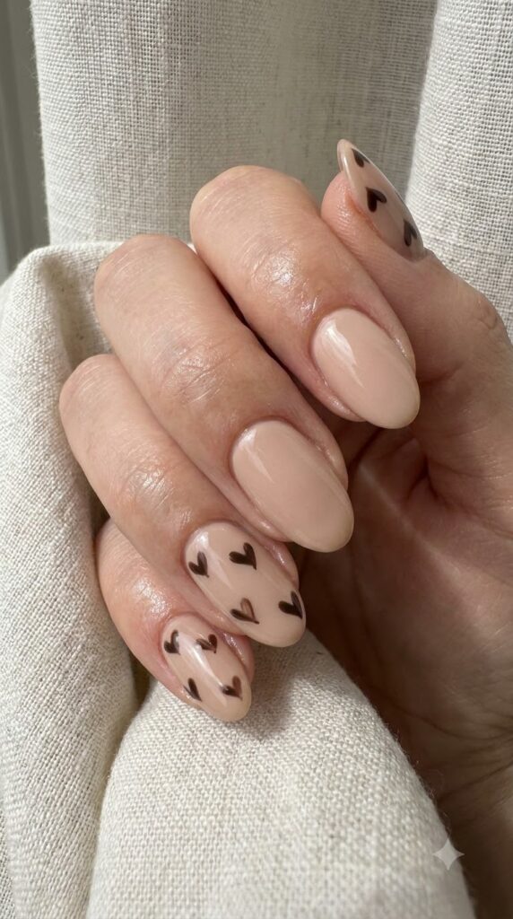 Oval beige nails with miniature hand-painted dark chocolate hearts