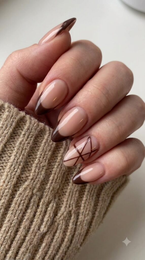 Almond nude nails with deep cocoa brown side-swept French tips