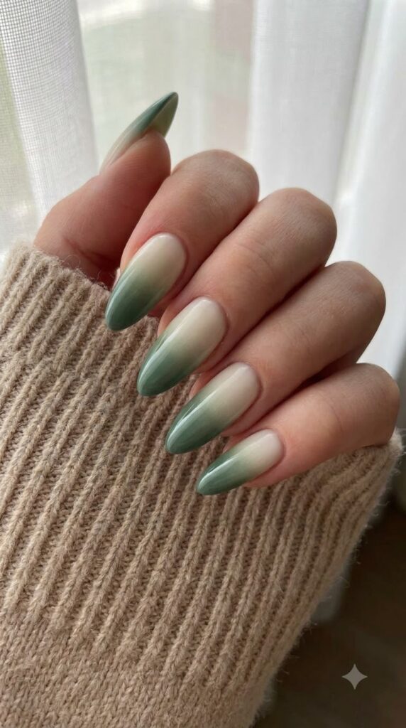 Almond nails with off-white base fading smoothly into deep sage green tips