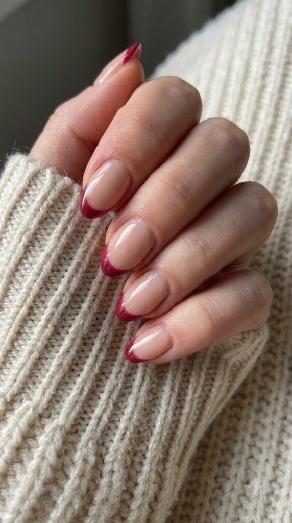 Short almond nude nails with crisp strawberry wine red-pink French tips