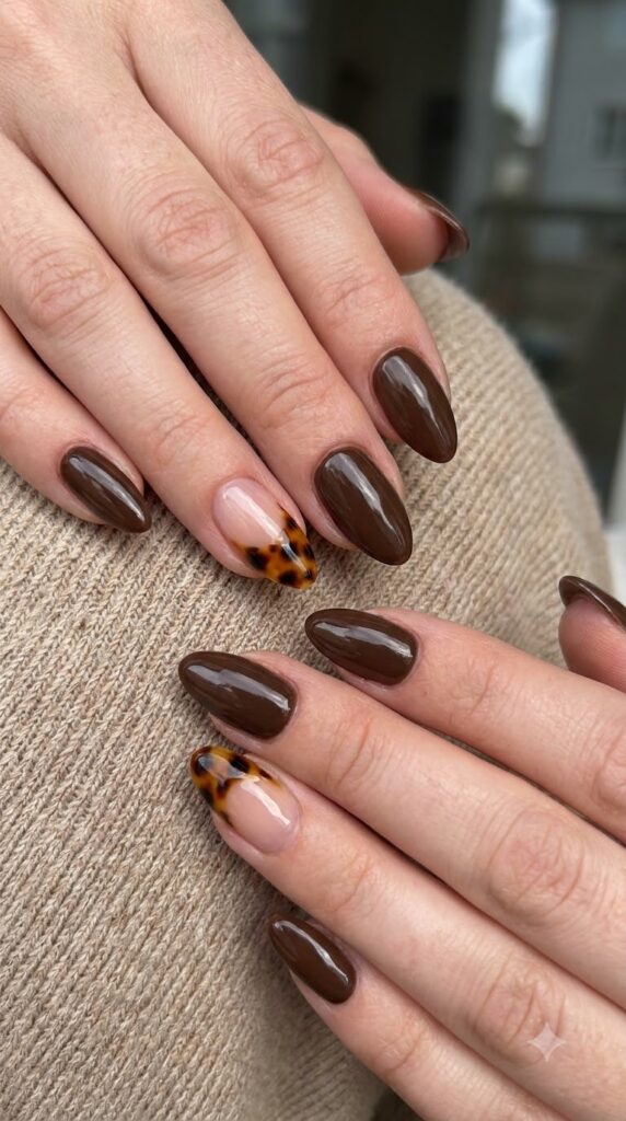 Medium almond espresso nails with classic tortoiseshell French tip accent