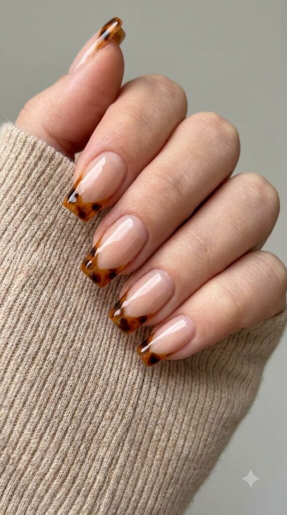 Medium square nude nails with V-cut amber and black tortoiseshell French tips